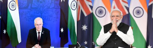 This combination photograph released by Indias Press Information Bureau shows Australian Prime Minister Scott Morrison, left and Indian Prime Minister Narendra Modi holding a virtual summit, march 21, 2022. Modi said Monday that the success of a U.S.-led bloc in countering China's rising influence was critical, after he met with Australia's leader to discuss the war in Ukraine and a major trade deal. (Press Information Bureau via AP)