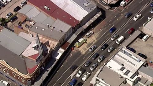 Fuel spills on major Sydney road after truck ruptures tank in median strip crash