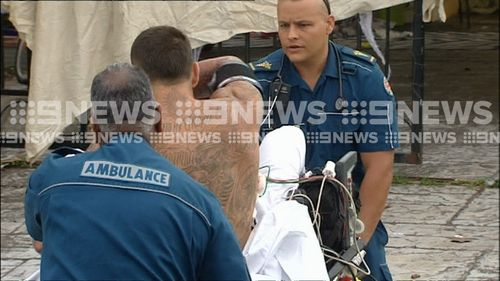 He was shown dramatically ripping off medical equipment before being tackled to the ground and wheeled away on a stretcher. (9NEWS)