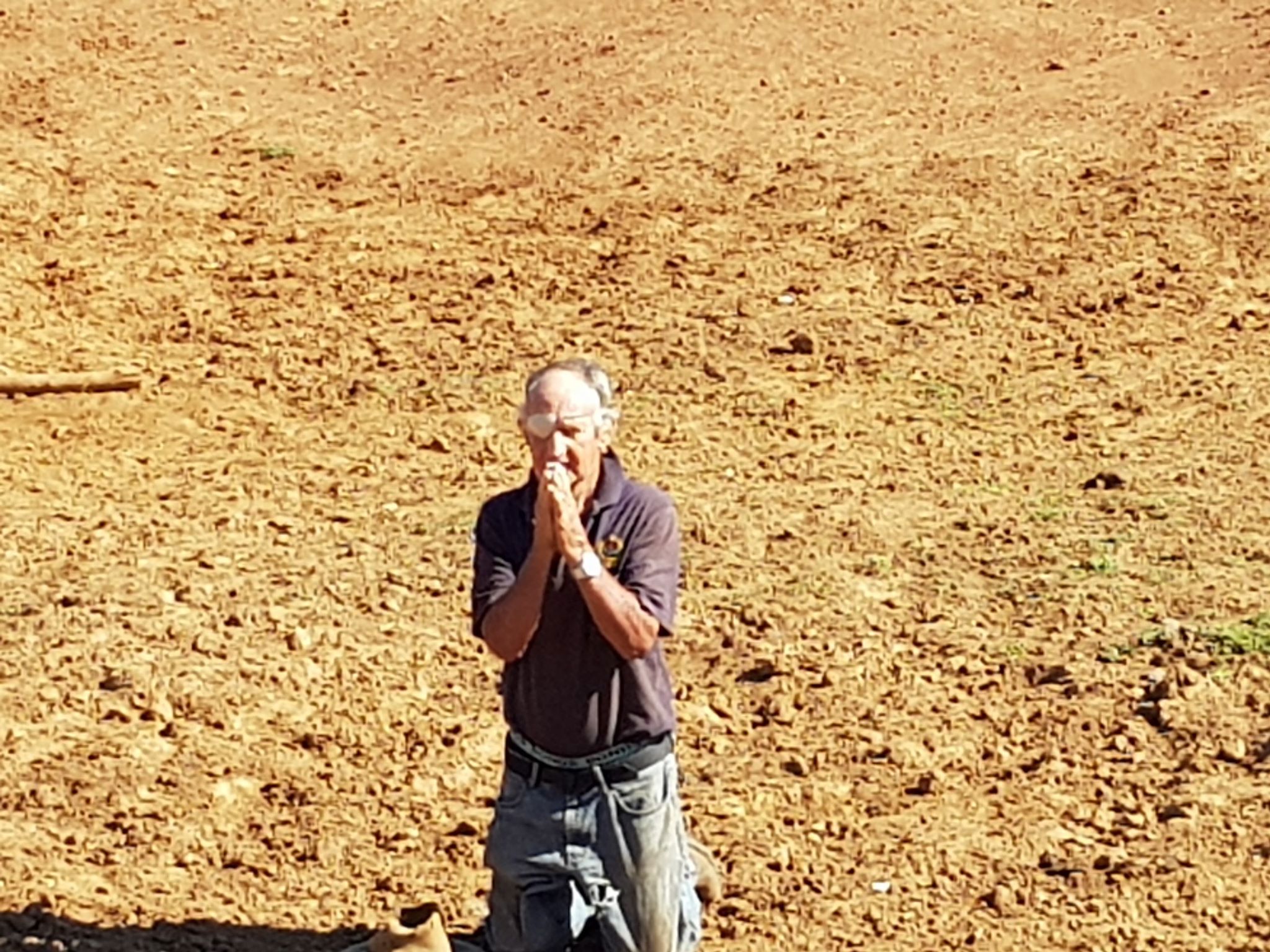 November 2018 Alf King was photographed praying for rain in a dry dam. 