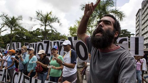 Protesters line the streets of Caracas, Venezuela. (AAP)