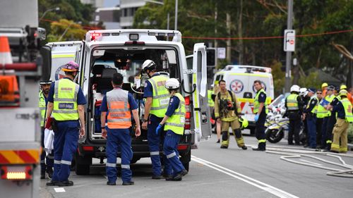 Paramedics work to treat a number of seriously injured patients following a truck crash.
