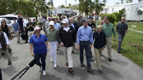 Mr Trump, Melania Trump, Florida Governor Rick Scott and his wife Ann Scott tour a neighbourhood affected by Hurricane Irma, in Naples, Florida. (AFP)