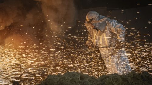 A worker in protective clothes melts steel at the Zaporizhstal Iron and Steelworks, one of the country's largest steel plants, in Zaporizhzhia, Ukraine, Thursday, Feb. 13, 2025. (AP Photo/Efrem Lukatsky)