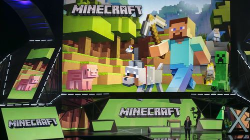 FILE - Lydia Winters shows off Microsoft's "Minecraft" built specifically for HoloLens at the Xbox E3 2015 briefing before Electronic Entertainment Expo, June 15, 2015, in Los Angeles. Security experts around the world raced Friday, Dec. 10, 2021, to patch one of the worst computer vulnerabilities discovered in years, a critical flaw in open-source code widely used across industry and government in cloud services and enterprise software. Cybersecurity experts say users of the online game Minecra