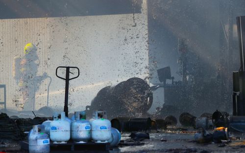 Multiple gas cylinders exploded during the blaze.