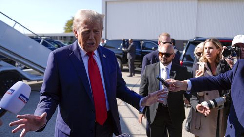 Republican presidential nominee former President Donald Trump speaks to reporters as he arrives at Detroit Metropolitan Wayne County Airport, Friday, Oct. 18, 2024, in Detroit. (AP Photo/Evan Vucci)
