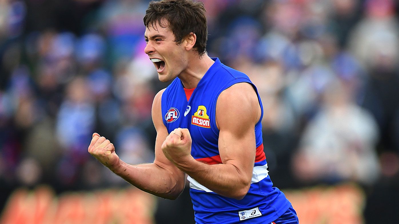 Josh Dunkley of the Bulldogs reacts after kicking a goal 