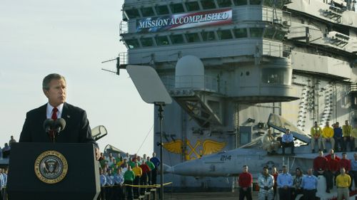 President George W Bush on board the aircraft carrier USS Abraham Lincoln in 2003.