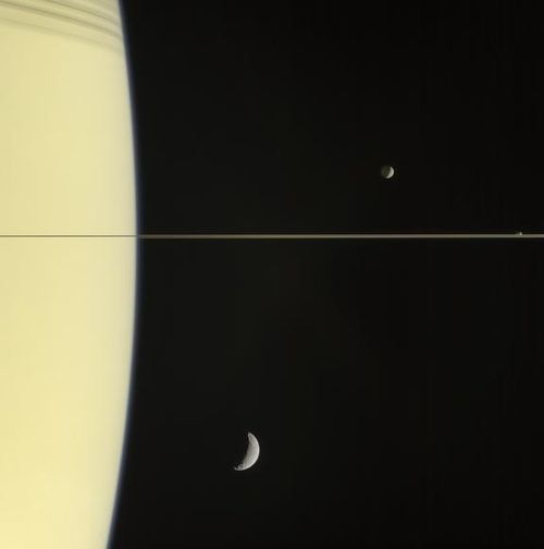 Saturn pictured with its moons Mimas and tiny Janus (above the rings), and Tethys (below the rings).