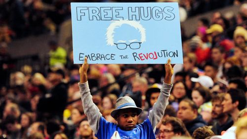 Devonte Hart holding up a sign as Democratic presidential candidate Bernie Sanders addressed the crowd during a rally.