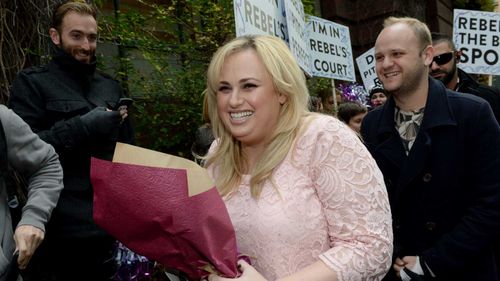Rebel Wilson is greeted by a cheer squad outside court in September last year. (AAP)