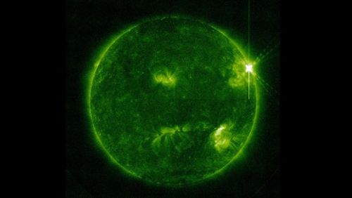 The sun pictured as a solar flare erupts from it.
