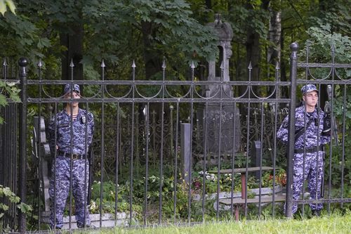 Russian Rosguardia (National Guard) servicemen guard the Porokhovskoye cemetery after a memorial service for mercenary chief Yevgeny Prigozhin, who was killed in a plane crash last week, in St. Petersburg, Russia, Tuesday, Aug. 29, 2023.  