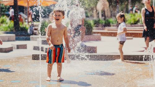 Sasha Ivanoff, three, cools off  at  Darling Harbour in Sydney.