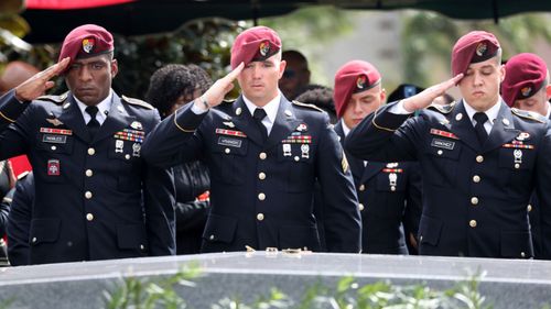 Members of the 3rd Special Forces Group Airborne 2nd Battalion leave pins and salute the casket after the burial of Army Sgt. La David Johnson. (AP)