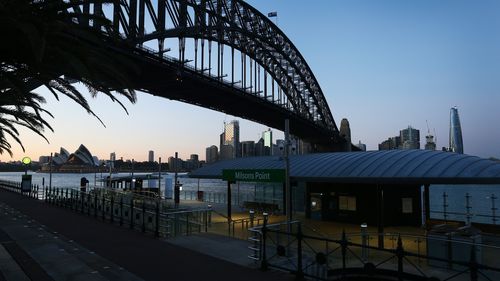 The Sydney Harbour Bridge is seen at sunrise from Milsons Point.