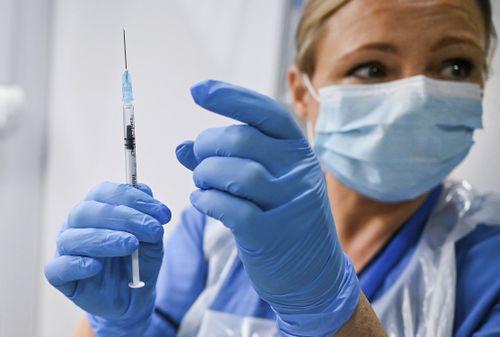 Grace Thomson (left) receives the first of two Pfizer/BioNTech Covid-19 vaccine jabs, administered Paula McMahon, at the NHS Louisa Jordan Hospital in Glasgow, on the first day of the largest immunisation programme in the UK's history. Care home workers, NHS staff and people aged 80 and over began receiving the jab this morning. PA Photo. Picture date: Tuesday December 8, 2020. See PA story HEALTH Coronavirus. Photo credit should read: Jeff Mitchell/PA Wire