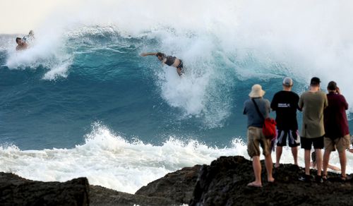 Wild winds and torrential waves batter the Queensland coast.