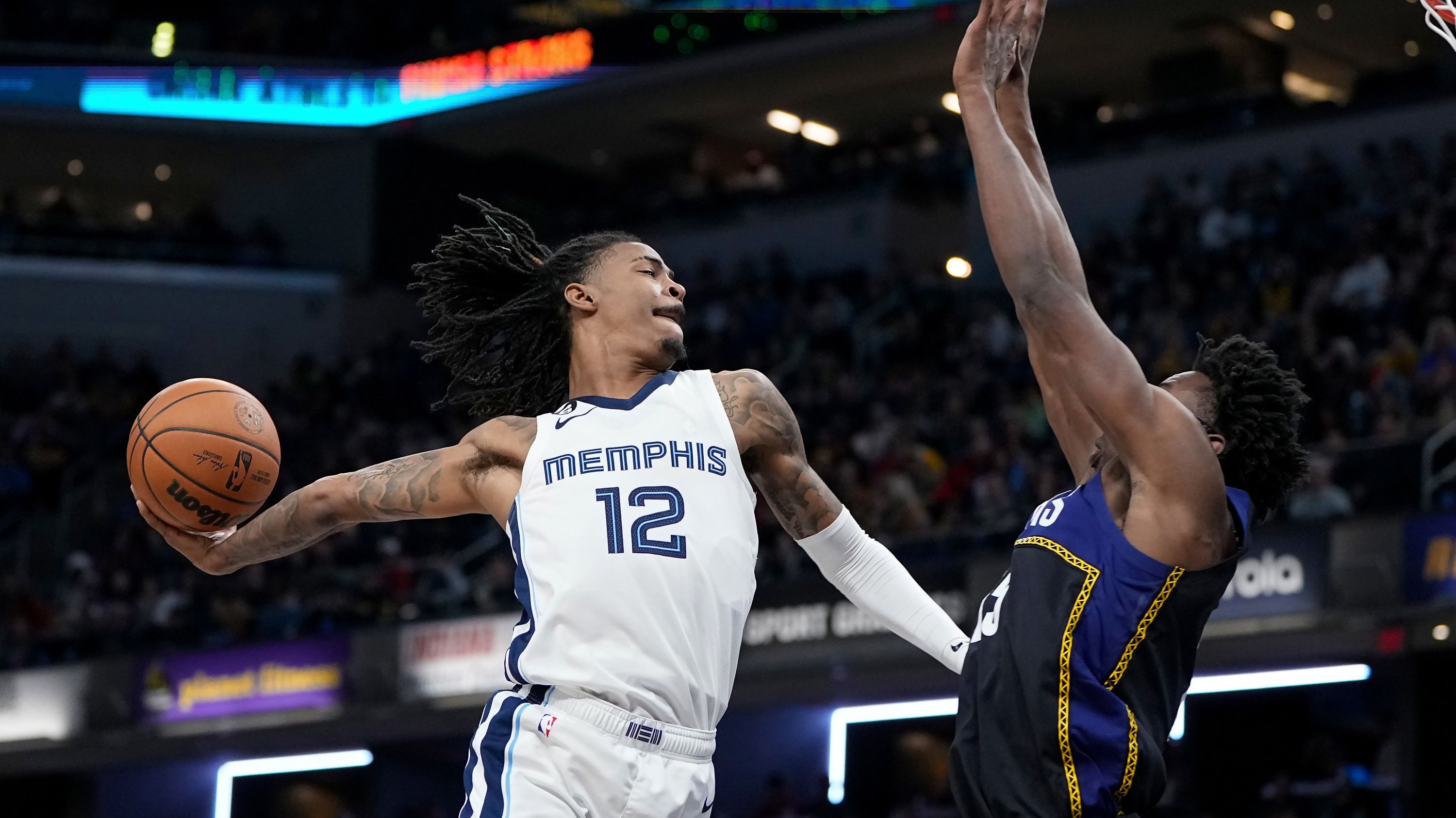 Ja Morant dunks the ball over Jalen Smith of the Indiana Pacers.