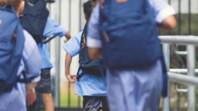 School children running into class