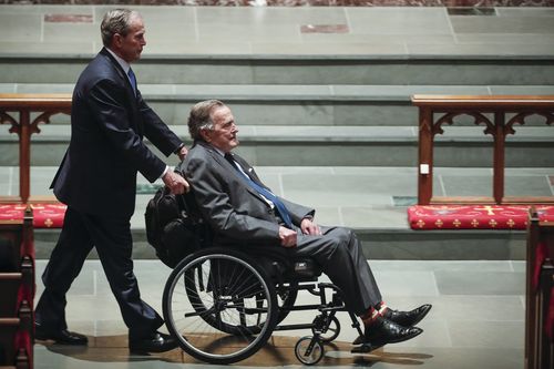 The two former presidents sat beside each other at the funeral in Houston. (AAP)