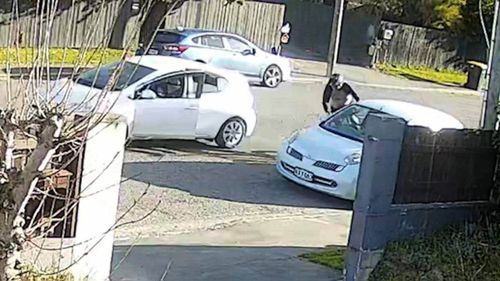 A security camera captured the moment a New Zealand mountainbiker, Mike Evans was deliberately knocked from his bike by the open door of a stolen car that police believe was driven by a child.