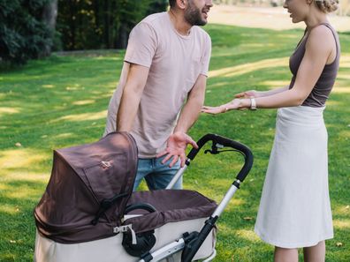 Couple fighting over baby in pram.