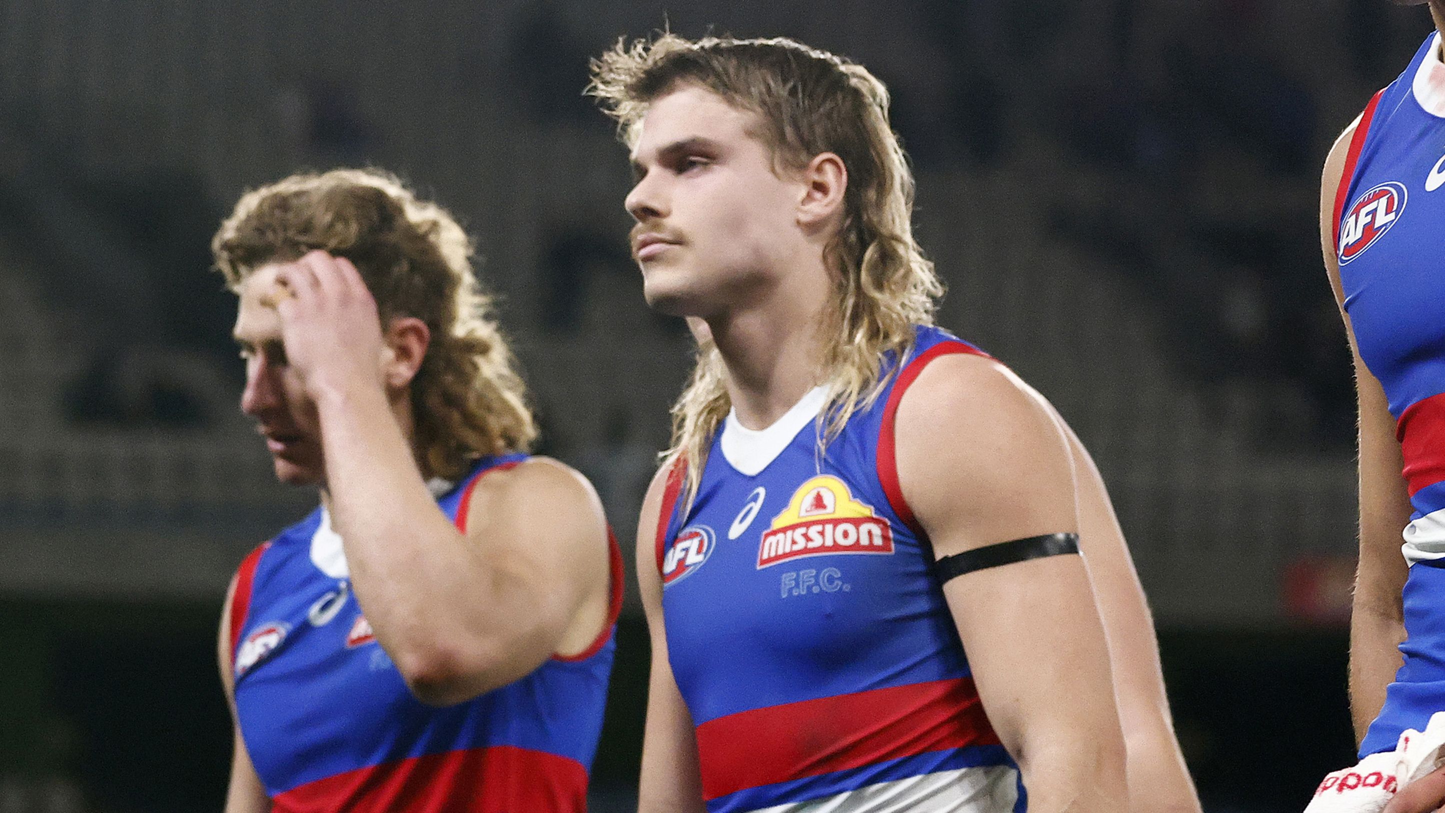 MELBOURNE, AUSTRALIA - AUGUST 20: Marcus Bontempelli of the Bulldogs (L) and his players look dejected as they leave the field after the round 23 AFL match between Western Bulldogs and West Coast Eagles at Marvel Stadium, on August 20, 2023, in Melbourne, Australia. (Photo by Daniel Pockett/Getty Images)