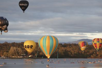 Hot air balloons over Lake Burley Griffin during the Canberra Balloon Spectacular festival in Canberra.