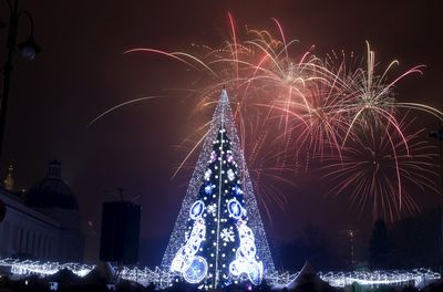 Fireworks light the sky above illuminated Christmas tree at the Cathedral Square in Vilnius, Lithuania.