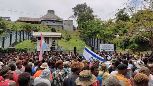 Protestors gather outside the parliament building in Honiara, Solomon Islands, November 24, 2021, in this screen grab obtained by Reuters, from a social media video (CNN).