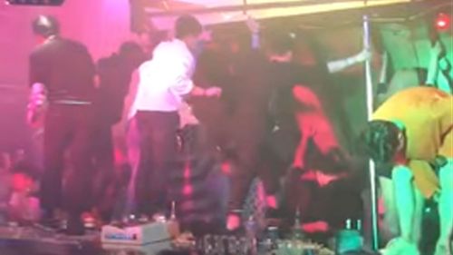 People attempt to support the ceiling of the Coyote Ugly night club after a balcony collapses.