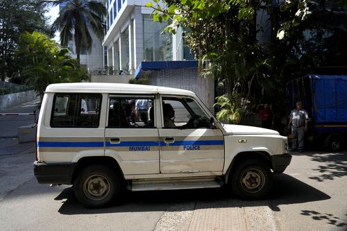 A police vehicle is seen parked at the gate of a building which houses BBC office, in Mumbai, India, Tuesday, Feb. 14, 2023.