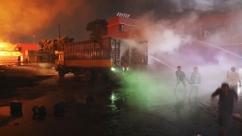 Firefighters work to contain a fire that broke out at the BM Inland Container Depot. (AP Photo)