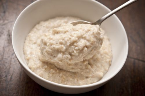 a bowl of oatmeal (porridge) on top with a spoon.