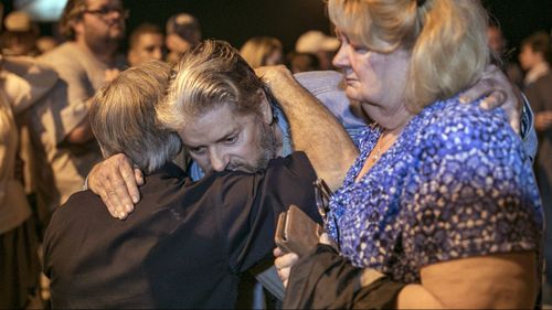 Texas Gov. Greg Abbott consoles Ted and Ann Montgomery, members of the First Baptist Church. (Image: AAP)
