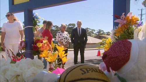 Tasmania Premier Peter Gutwein places flowers at a memorial site