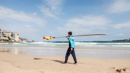 A lifeguard removes a flag.