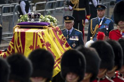 King Charles III and Prince William follow the coffin of Queen Elizabeth II, draped in the Royal Standard with the Imperial State Crown placed on top, carried on a horse-drawn gun carriage of the King's Troop Royal Horse Artillery, during the ceremonial procession from Buckingham Palace to Westminster Hall, London, Wednesday Sept. 14, 2022. 