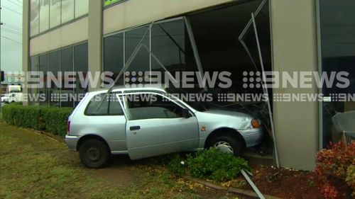 The silver Toyota Starlet has smashed through the windows of a carpet store in Clyde. (9NEWS)
