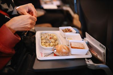 Close up on the airplane food being opened up.