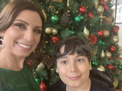 Jo Abi and son Philip standing in front of a Christmas tree