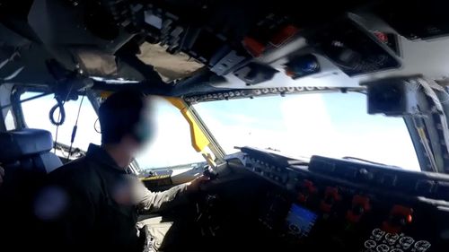 A video captured from the RC-135's cockpit shows the Chinese fighter jet streak across the sky just ahead of the aircraft 