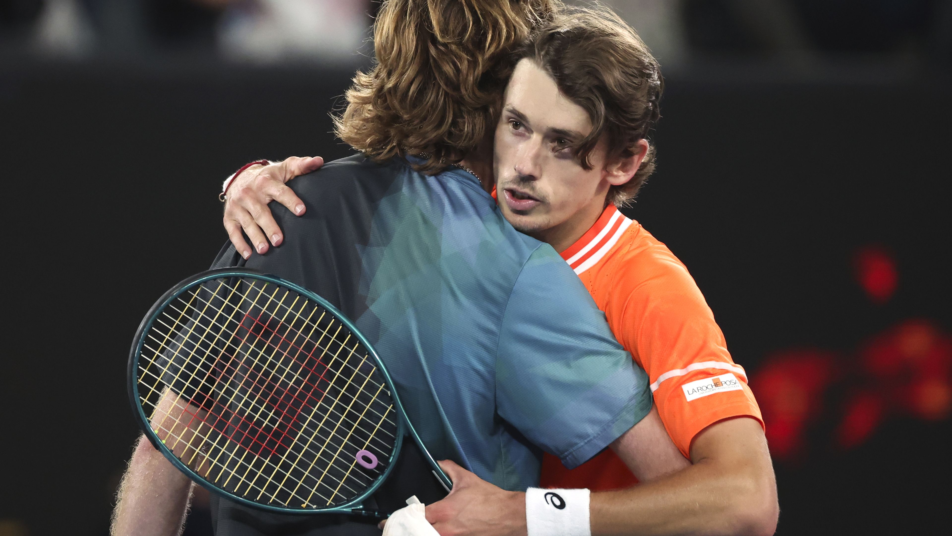 Andrey Rublev of Russia is congratulated by Alex de Minaur.