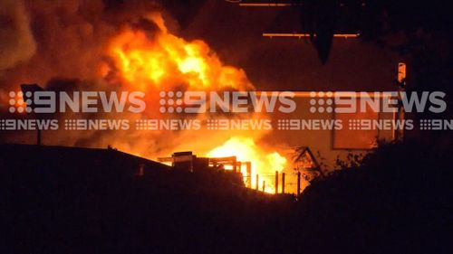 Residents were seen on roofs, trying to prevent embers from reaching their homes. (9NEWS)