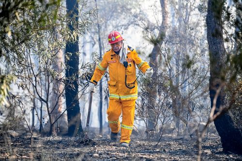 NSW RFS fire fighter Ken Middleton is seen in Gandangara Estate Barden Ridge. (AAP)