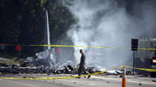 The crashed plane narrowly missed drivers on the busy highway. (AAP)