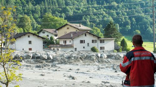 Eight people remain missing a day after mud- and rockslides swept through the small Swiss village near the Italian border. (AP)