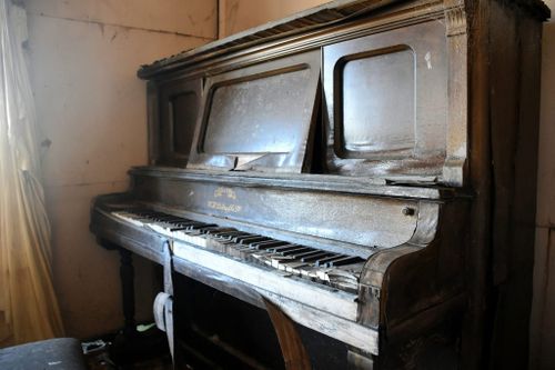 Ravaged by time, the piano sits in the parlour of the abandoned NSW hotel.